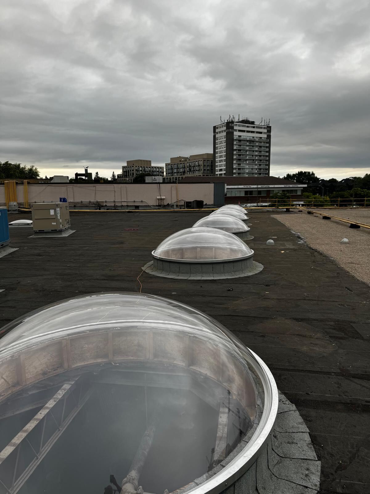 Row of dome skylights installed on a commercial flat roof in the GTA