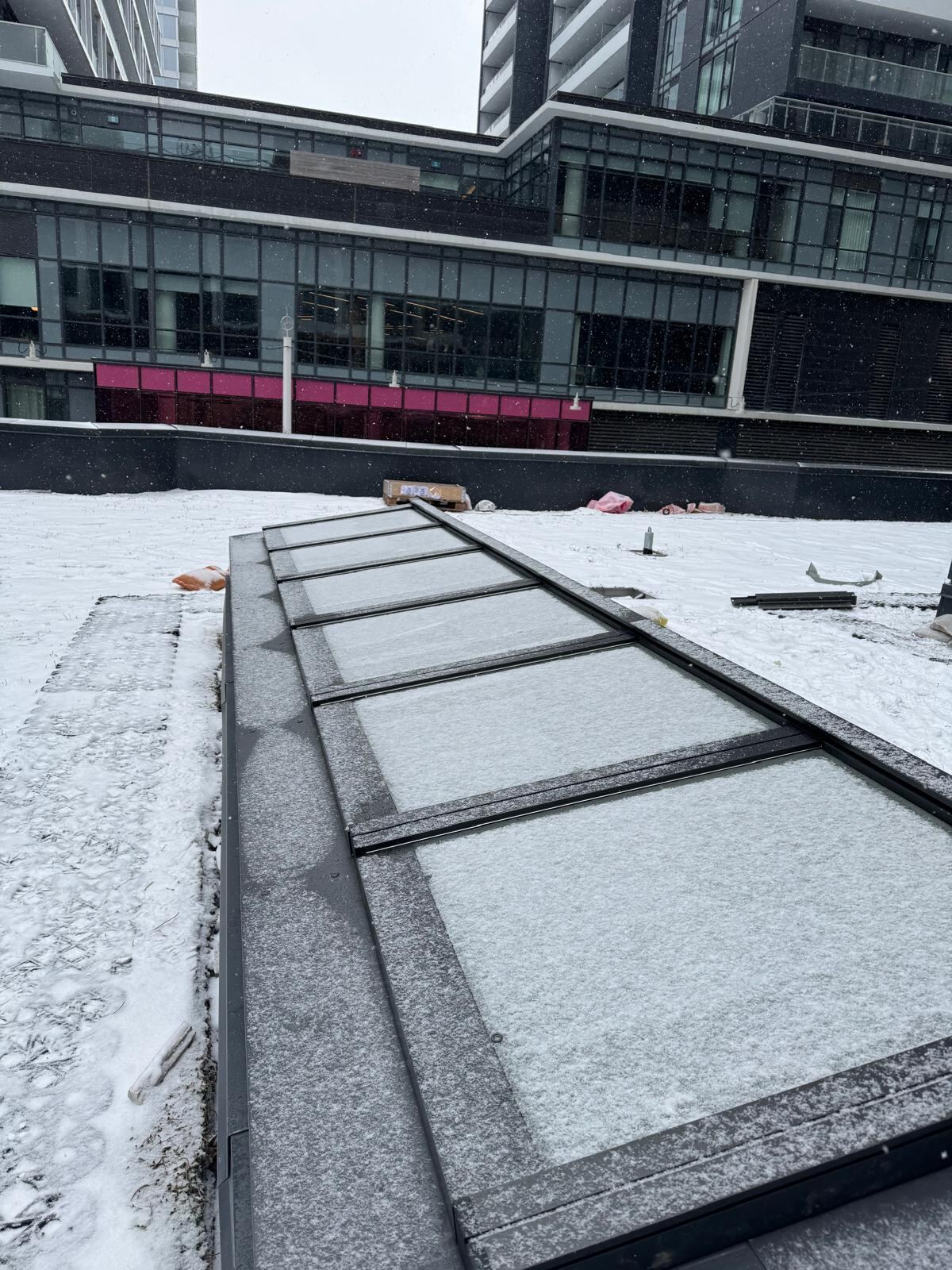 Skylight installation on a commercial roof in winter