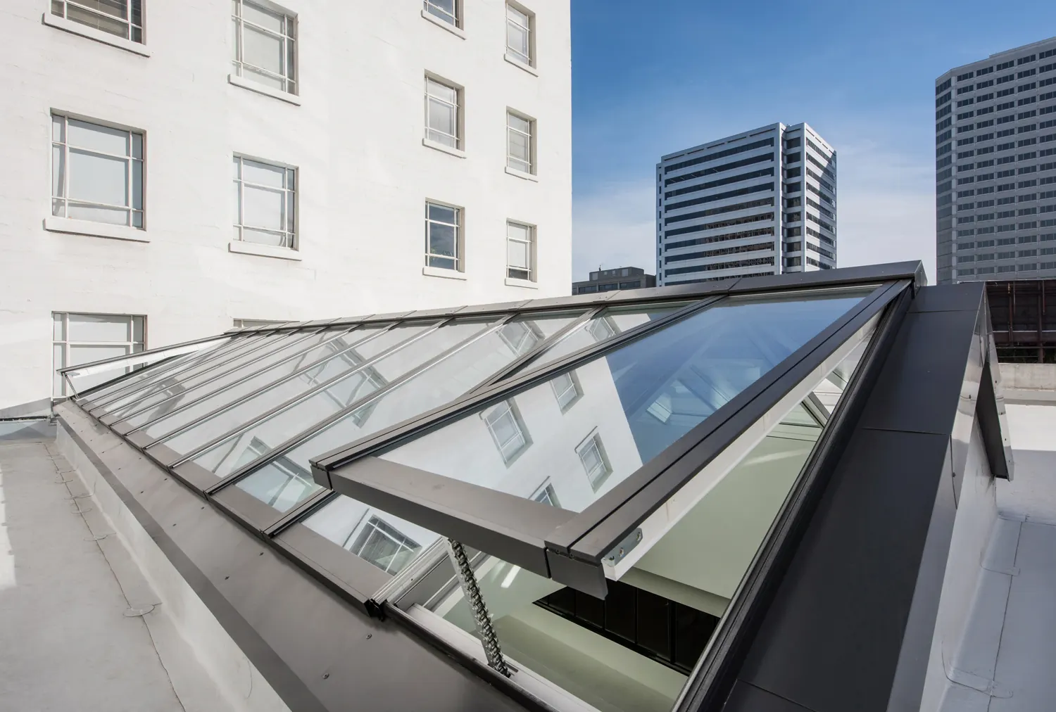 A VELUX Modular Skylight ridgelight run over an office floor, seen from the roof